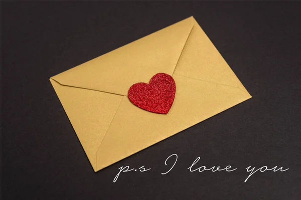 Valentines envelope with heart near ps i love you lettering on black — Stock Photo