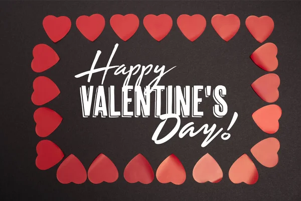 Top view of happy valentines day lettering in frame of hearts on black — Stock Photo