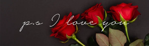 Top view of red roses near ps i love you lettering on black, banner — Stock Photo