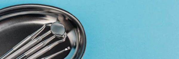 Dental tools on metal tray on blue background, banner — Stock Photo