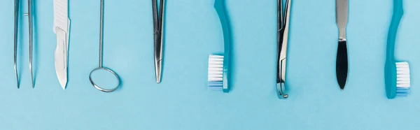 Top view of toothbrushes and dental tools on blue background, banner — Stock Photo