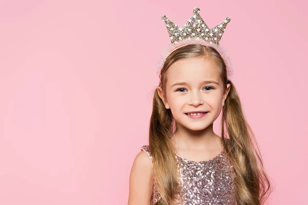 Happy little girl in crown smiling isolated on pink — Stock Photo