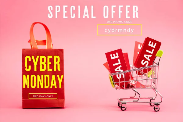 Red tags with sale in shopping trolley near paper bag with cyber monday lettering on pink — Stock Photo