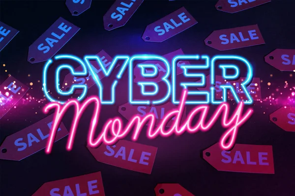 Neon Cyber Monday Schriftzug in der Nähe von roten Etiketten auf schwarzem Hintergrund — Stockfoto