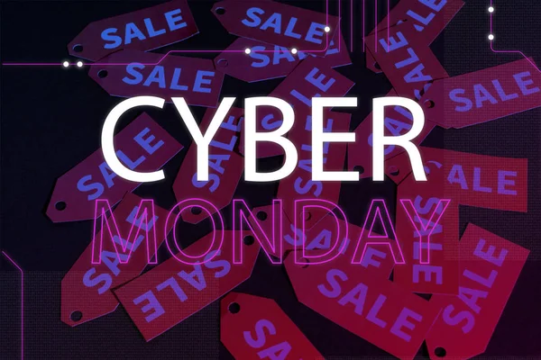 Cyber monday lettering near red labels on black background — Stock Photo