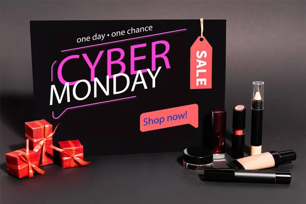 Placard with one day, one chance, cyber monday lettering and gifts near decorative cosmetics on dark background — Stock Photo