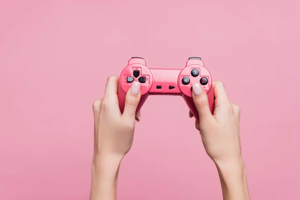 KYIV, UKRAINE - OCTOBER 26, 2020: partial view of woman holding joystick in hands isolated on pink — Stock Photo
