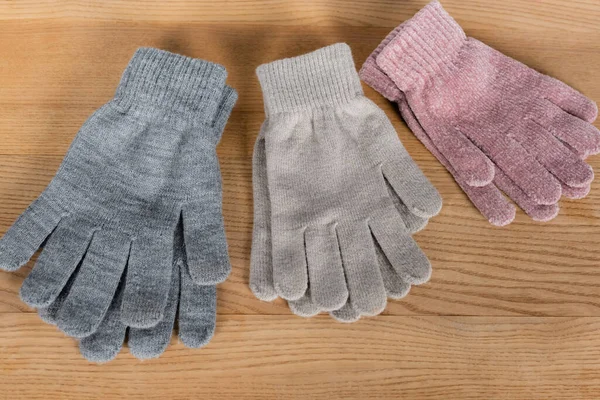 Vue de dessus des gants chauds sur la surface en bois — Photo de stock