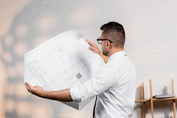 Architect holding blueprint in architectural agency — Stock Photo