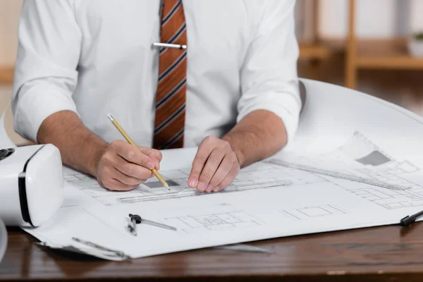 Cropped view of architect drawing on blueprint with pencil and ruler near vr headset — Stock Photo