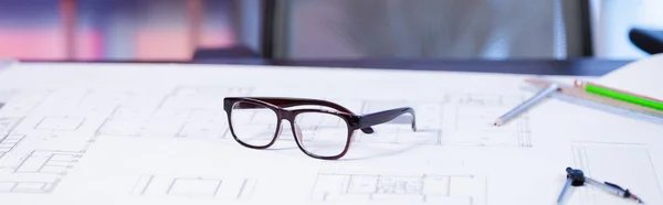 Selective focus of eyeglasses on blueprint in architectural agency, banner — Stock Photo