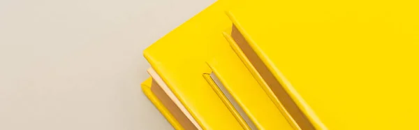 Yellow copy books isolated on grey, banner — Stock Photo