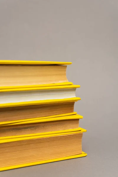 Stack of yellow notebooks isolated on grey — Stock Photo