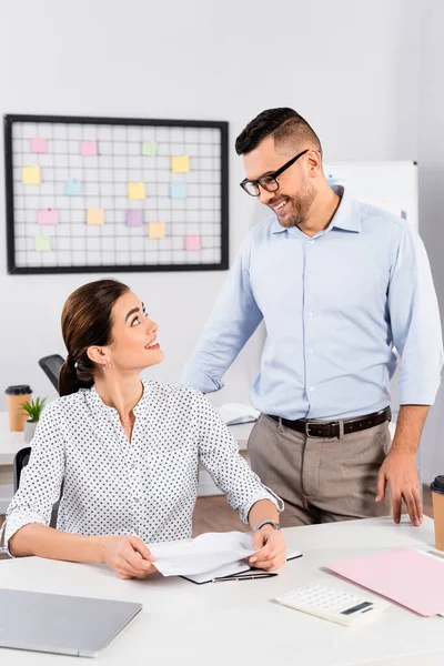 Cheerful business people looking at each other in office — Stock Photo