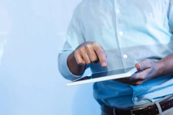 Partial view of businessman pointing with finger at digital tablet with blank screen — Stock Photo