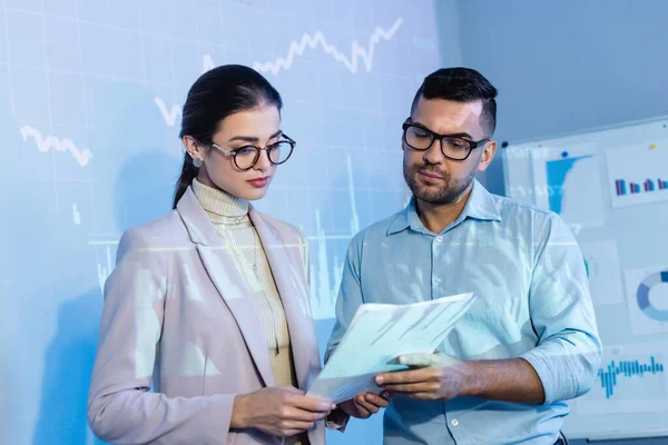 Business people in glasses looking at documents in office — Stock Photo