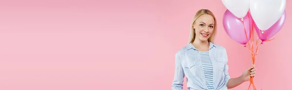 Happy woman standing and holding balloons isolated on pink, banner — Stock Photo