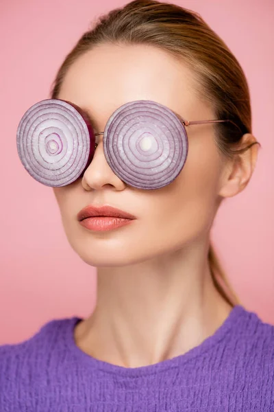 Close up view of woman with onion rings eyeglasses isolated on pink, surrealism concept — Stock Photo