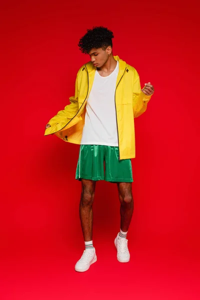 Full length of stylish african american man standing on red — Stock Photo