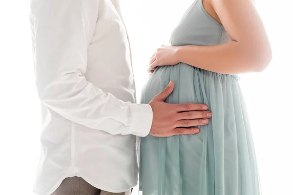 Cropped view of man in white shier touching belly of pregnant wife isolated on white — Stock Photo