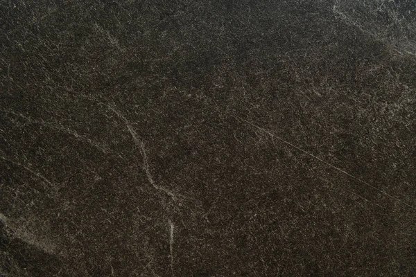 Background of black marble surface with streaks, top view — Stock Photo