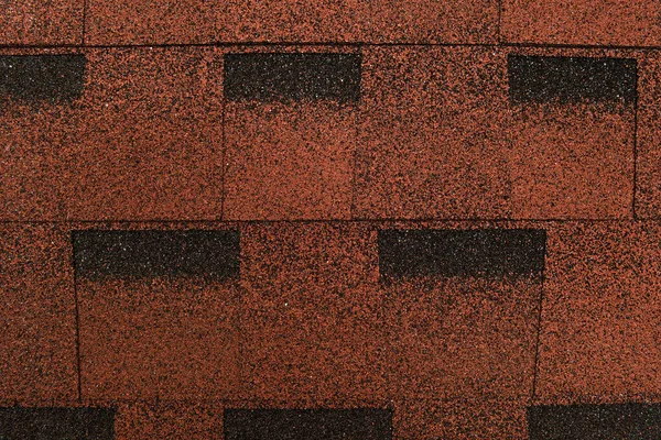 Brown, grainy background of bituminous roofing tiles, top view — Stock Photo