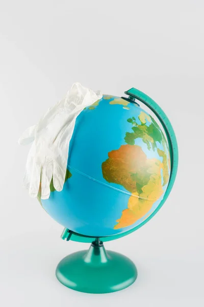 Latex gloves on globe isolated on grey, ecology concept — Stock Photo