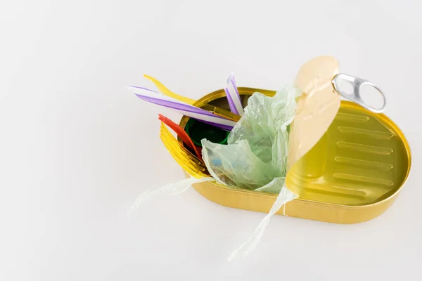 Cellophane and plastic garbage in can on white, ecology concept — Stock Photo