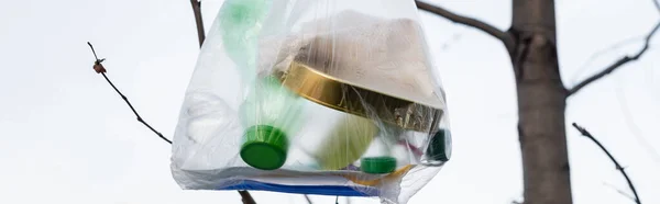 Bolsa de plástico con basura en el árbol, concepto de ecología, bandera - foto de stock