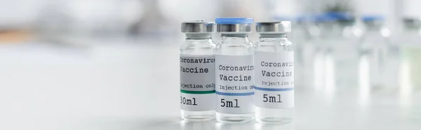 Close up view of jars with coronavirus vaccines in laboratory, banner — Stock Photo