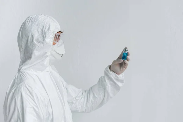 Scientist looking at jar with vaccine — Stock Photo