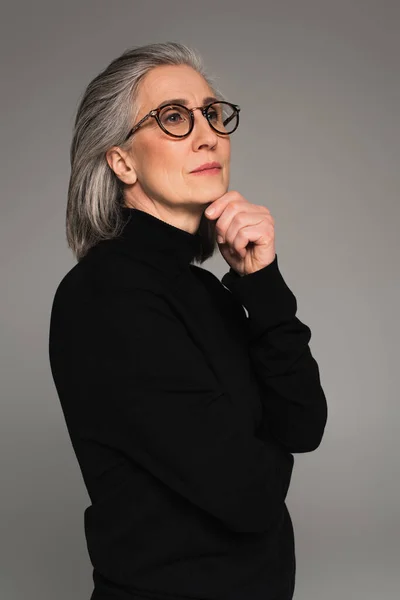 Portrait of woman in turtleneck and eyeglasses isolated on grey — Stock Photo