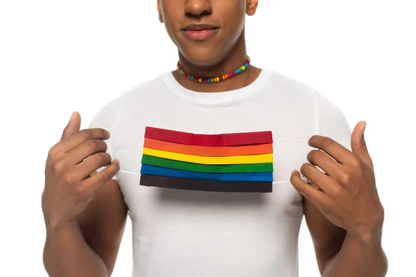 Cropped view of african american man holding lgbt colors medical mask isolated on white — Stock Photo