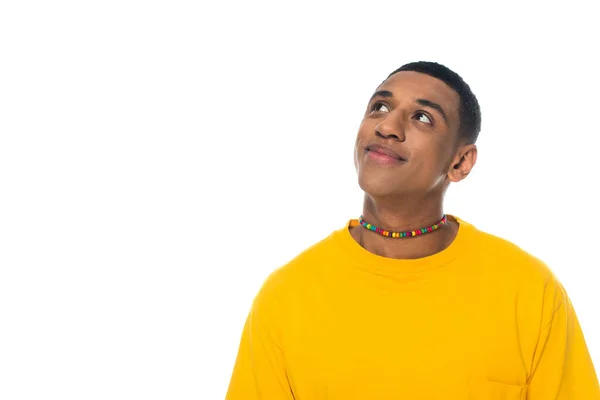 Dreamy and positive african american man in rainbow colors necklace isolated on white, lgbt concept — Stock Photo