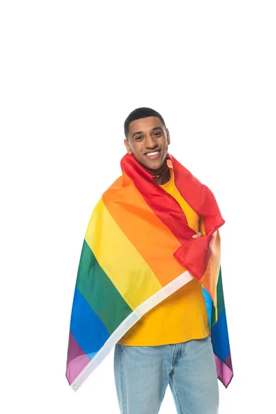 Cheerful african american man, covered with lgbt flag, looking at camera isolated on white — Stock Photo