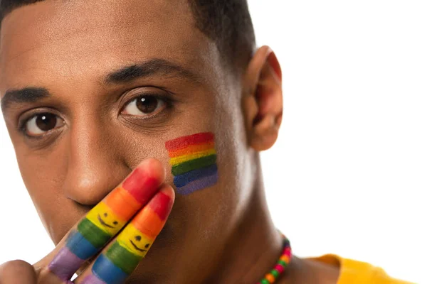 African american man covering mouth with fingers painted in lgbt colors isolated on white — Stock Photo