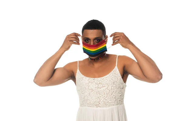 African american transsexual man putting on lgbt colors medical mask isolated on white — Stock Photo