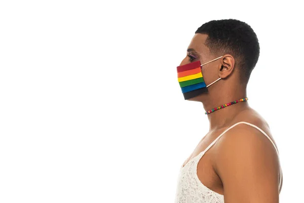 Vista laterale di afro americano transgender donna indossa colori lgbt maschera medica isolato su bianco — Foto stock