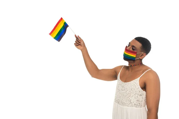 African american transgender woman, wearing rainbow colors medical mask and holding lgbt flag isolated on white — Stock Photo