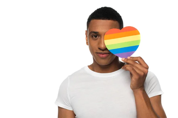 African american man obscuring face with lgbt colors paper heart isolated on white — Stock Photo