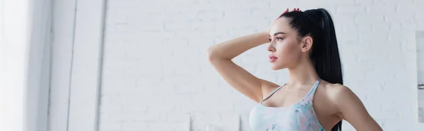 Pretty woman in sports bra looking away at home, banner — Stock Photo