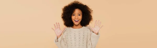 Excited african american preteen girl with hands up showing palms isolated on beige, banner — Stock Photo