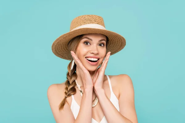 Cheerful woman in straw hat looking at camera isolated on blue — Stock Photo
