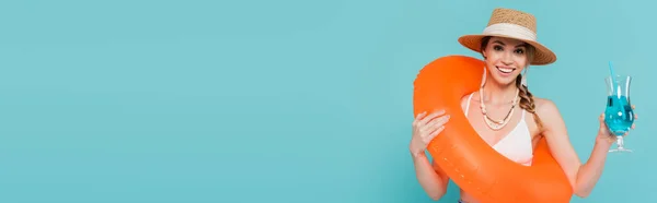 Cheerful woman with swim ring and cocktail isolated on blue, banner — Stock Photo