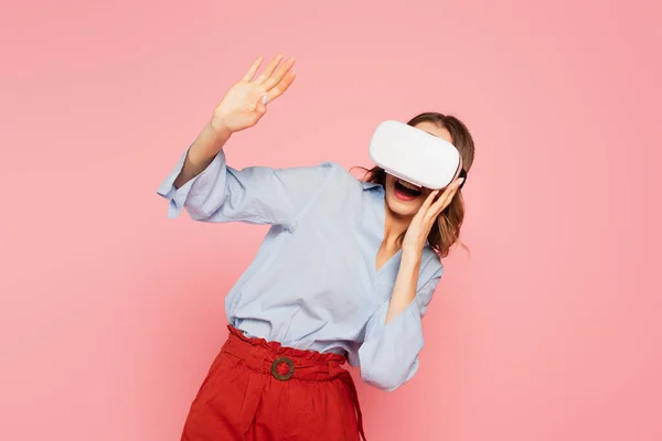 Aufgeregte Frau in vr Headset winkt Hand isoliert auf rosa — Stockfoto