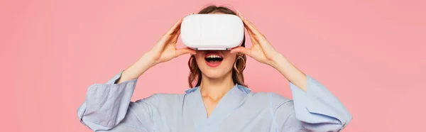 Amazed woman in vr headset isolated on pink, banner — Stock Photo