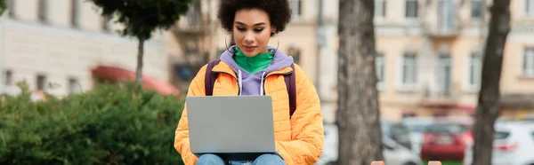 African american woman using laptop outdoors, banner — Stock Photo