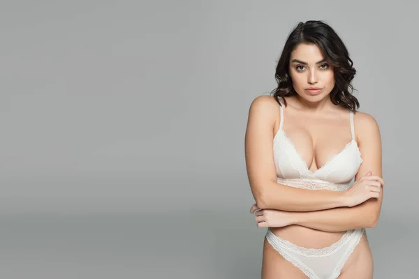 Sensual woman in lingerie looking at camera isolated on grey with copy space — Stock Photo