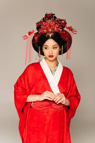 Pretty asian woman in oriental clothes isolated on grey — Stock Photo
