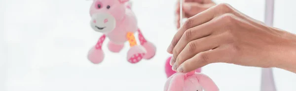 Cropped view of young woman holding toys, banner — Stock Photo